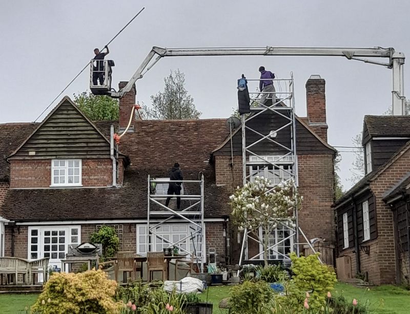 The Roof Moss Cleaners using cherry picker and scaffolding to clean roof safely and professionally in Woodstock, Oxfordshire