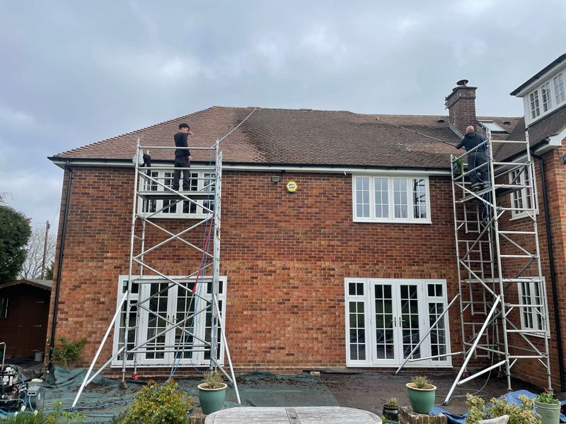 Roof cleaning carried out safely from scaffold towers by The Roof Moss Cleaners in Woodstock